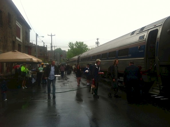 The southbound Vermonter makes its station stop at Brattleboro at noontime on a damp Train Day.